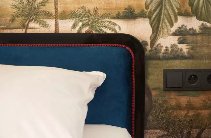 bed headrest trimmed with burgundy silk roller