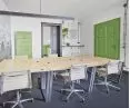 Green tiled stove and door in the office space of DESKoteka in Chorzow