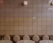 square ceramic tiles are arranged in alternating glossy and matte strips