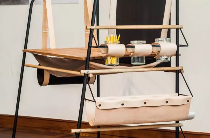 The desk is made of wood, steel and leather