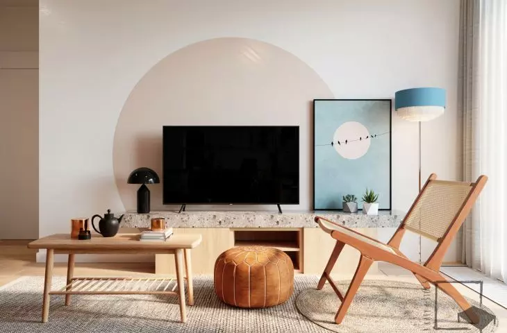 Behind the TV is painted a shape reminiscent of the setting sun