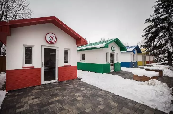 An exterior view of the different colored houses of the Dog Village