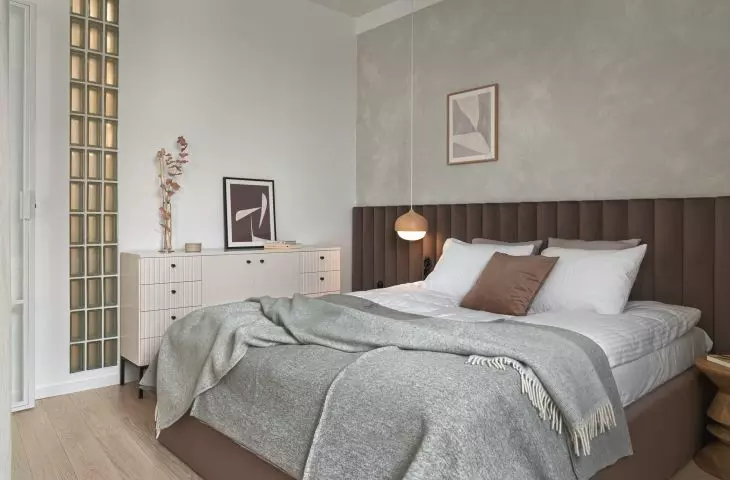 The bedroom space is occupied by a large bed