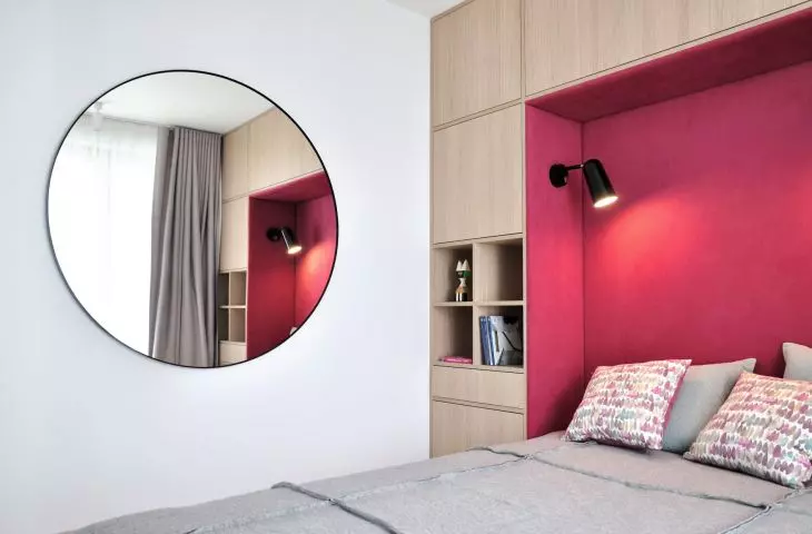 Upholstered pink headrest in bedroom 