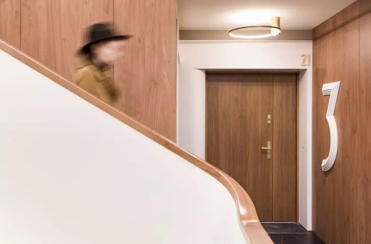 finished with wood veneer, the staircase gained convex Corian markings