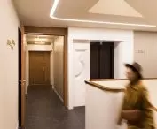 The prefabricated elevator portals with these concave carvings of numbers were made of Corian