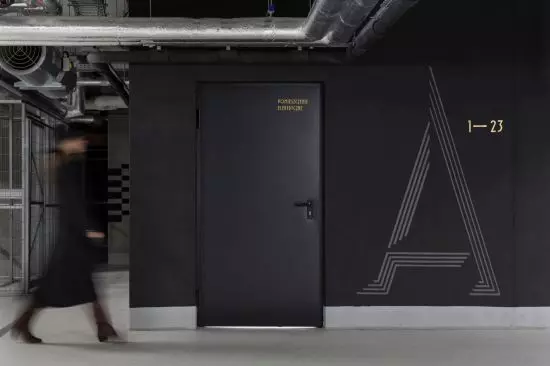 malowane on black walls signs in the garage resemble the sculpted shapes of the other signs
