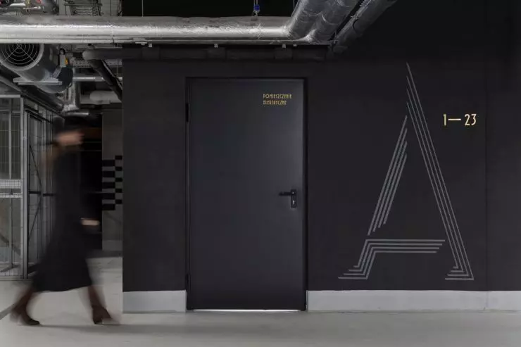 malowane on black walls signs in the garage resemble the sculpted shapes of the other signs