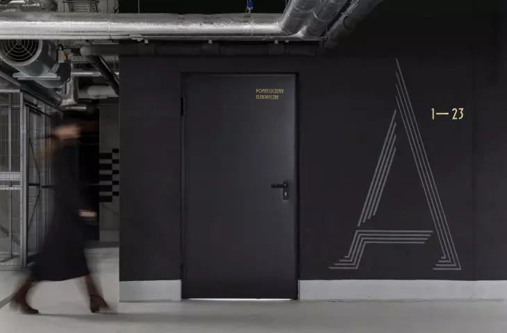 painted on black walls, the signs in the garage resemble the carved shapes of the other signs