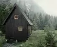 The facade of the house is made of tan boards