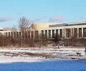 A riverside panorama of the Poznan University of Technology campus. 