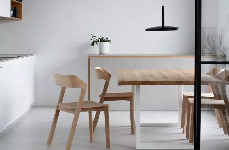Above the kitchen table hangs a designer Poet lamp