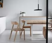 Above the kitchen table hangs a designer Poet lamp