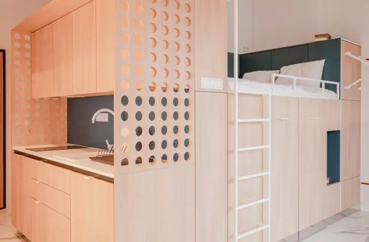 the kitchen area of the box is separated by an openwork wall
