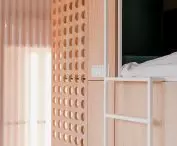 the bed is surrounded by low walls in dark green color
