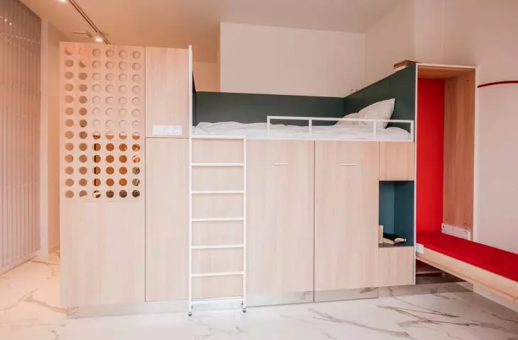 box serves multiple functions - houses kitchen, storage areas, bedroom and seating