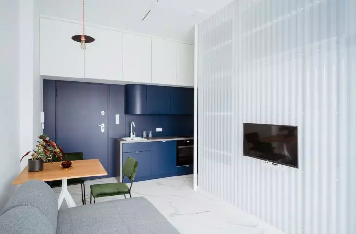 a larger studio apartment consists of two rooms - a living room with a kitchen and a bedroom deep inside
