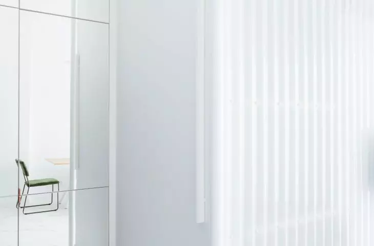 in the central part of the apartment stood a bathroom, which is separated from the living room by a wall of white corrugated sheet metal