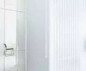 in the central part of the apartment stood a bathroom, which is separated from the living room by a wall of white corrugated sheet metal