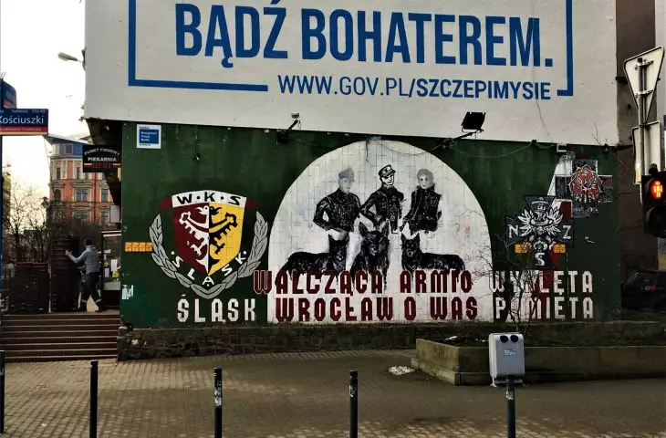Lower mural of supporters of Slask Wroclaw club on the south gable wall of the building