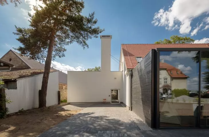 A communist-era extension with a distinctive large chimney 