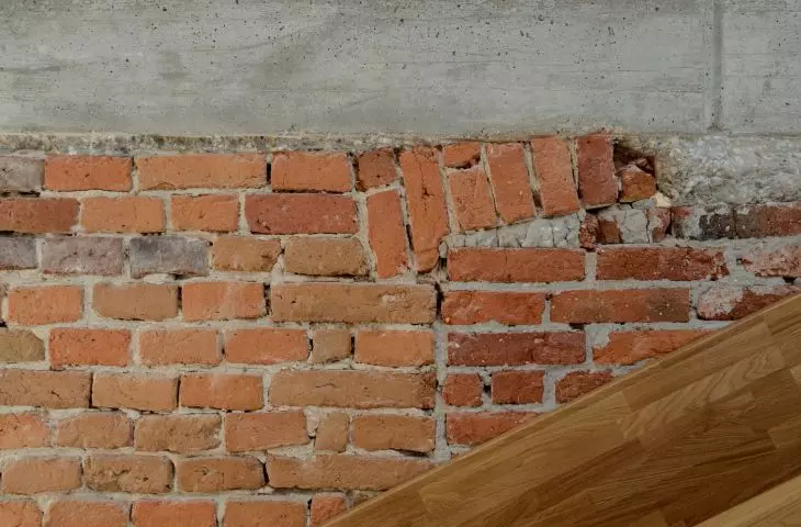 A fragment of the slide against the raw walls of the building
