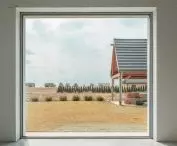 large windows frame views of the garden