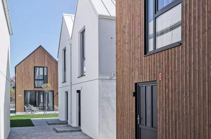 Facades covered with wood and white plaster