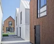 Facades covered with wood and white plaster