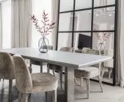 The dining room space is enlarged by mirrors