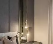 Upholstered wall and gold lamps in the bedroom