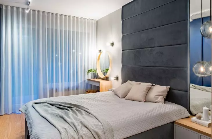 Comfortable bed with upholstery in the bedroom