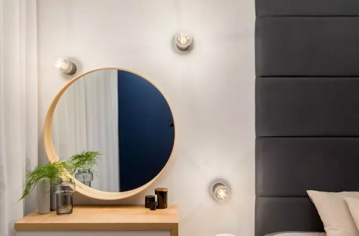 Toilet with round mirror in the bedroom