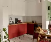 The kitchen area is defined by a floor in a colorful terrazzo pattern