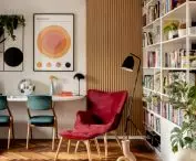 the living room is separated from the hallway by a high, openwork bookcase