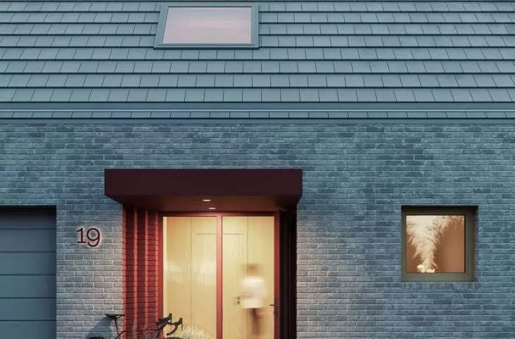 Colorful accents emphasize the entrance to the house and the shed added to the block