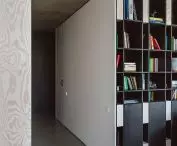 White cubicle includes bedroom and bookcase