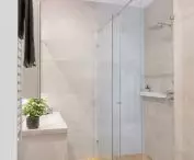 Bright bathroom with imitation oak flooring