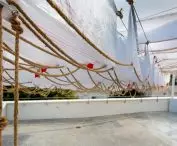on metal cables, the designers hung a decoration made of white bags 