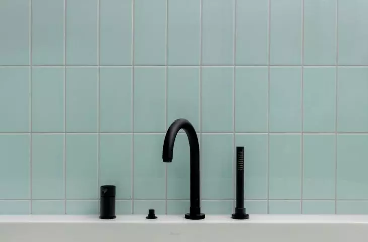 Black fixtures add a modern touch to the bathroom