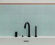 Black fixtures add a modern touch to the bathroom