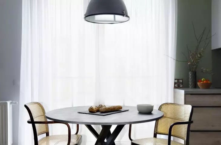 MInijadalnia in a room that serves as a dining room, kitchen, living room and workspace