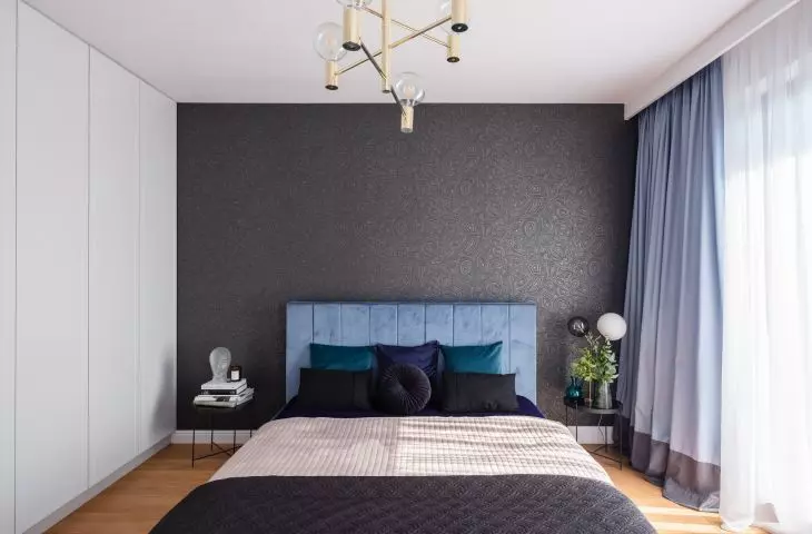Bedroom with black theme on the wall 