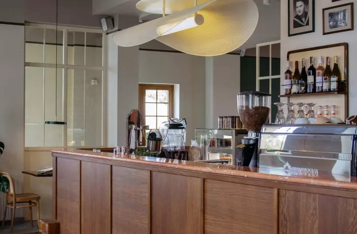 above the bar hangs a lamp designed especially for this space with a light form
