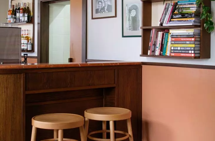 old photographs hang on the wall behind the bar