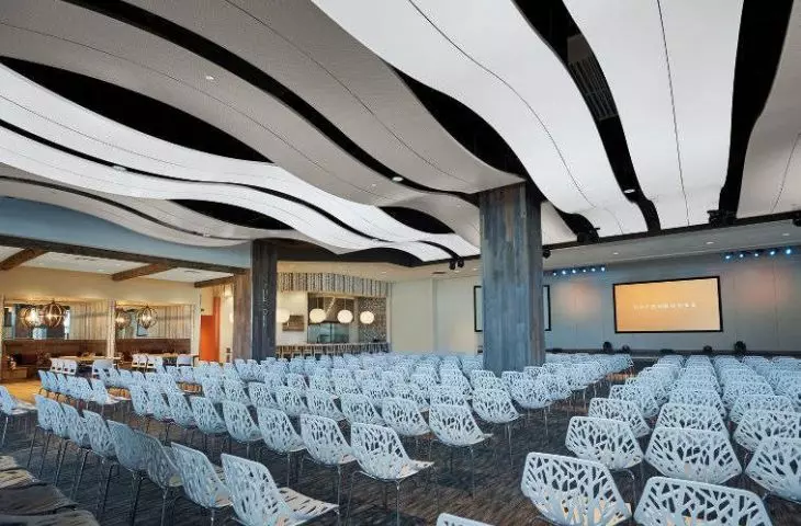 Spatial ceiling tiles by Knauf Ceiling Solutions in the conference room of a Warsaw office building