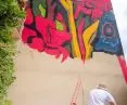 Grzegorz Ilski during the creation of the mural