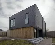 Facade covered with Cedral small format tile in graphite color (horizontal covering)  