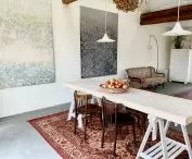 large table in the Studio, on the wall hang paintings by Kasia Listwan