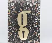 The cubes were made from a mixture of terrazzo and stone. The letters were made of brass